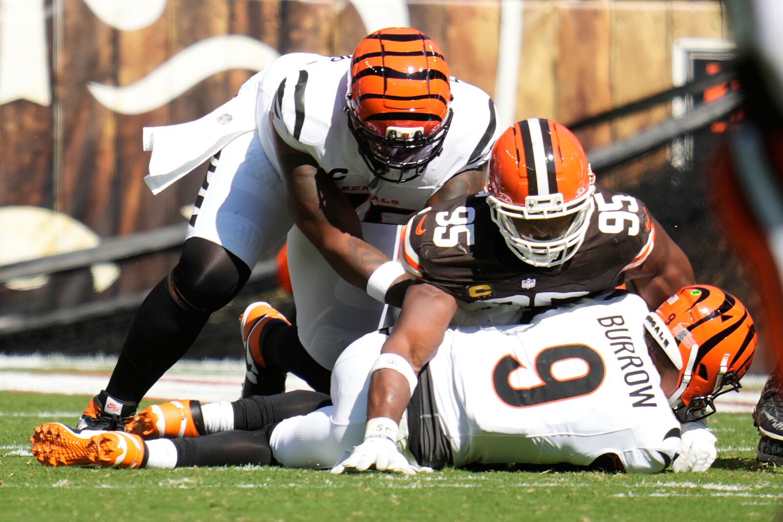Cincinnati Bengals quarterback Joe Burrow (9) is sacked by Cleveland Browns defensive end Myles Garrett (95) during the second half of an NFL football game Sunday, Sept. 7, 2025, in Cleveland. (AP Photo/Sue Ogrocki)