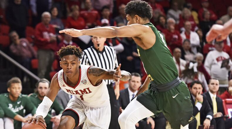 Miami’s Nike Sibande dribbles under Wright State’s Mark Hughes during their game Tuesday, Nov. 14 at Millett Hall on the Miami University Campus in Oxford. NICK GRAHAM/STAFF
