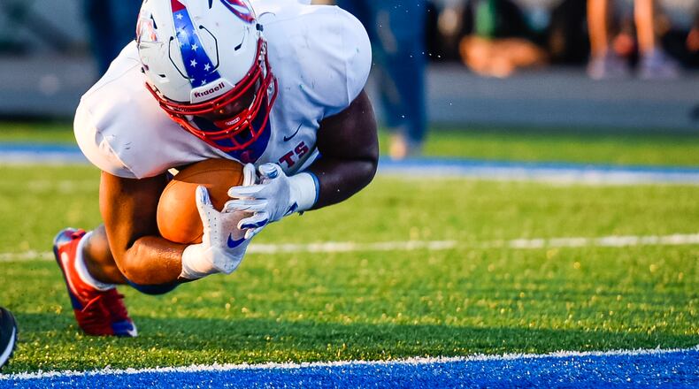 Carroll’s Frederick Butts gets tripped up as he dives for a touchdown. NICK GRAHAM/STAFF