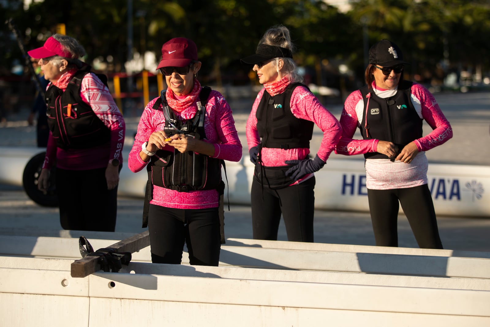 The Rosas Va'a Hawaiian canoeing team, whose members are women who have undergone cancer treatment, gather on Charitas Beach to train on the water in Niteroi, Rio de Janeiro state, Thursday, June 26, 2025. (AP Photo/Bruna Prado)