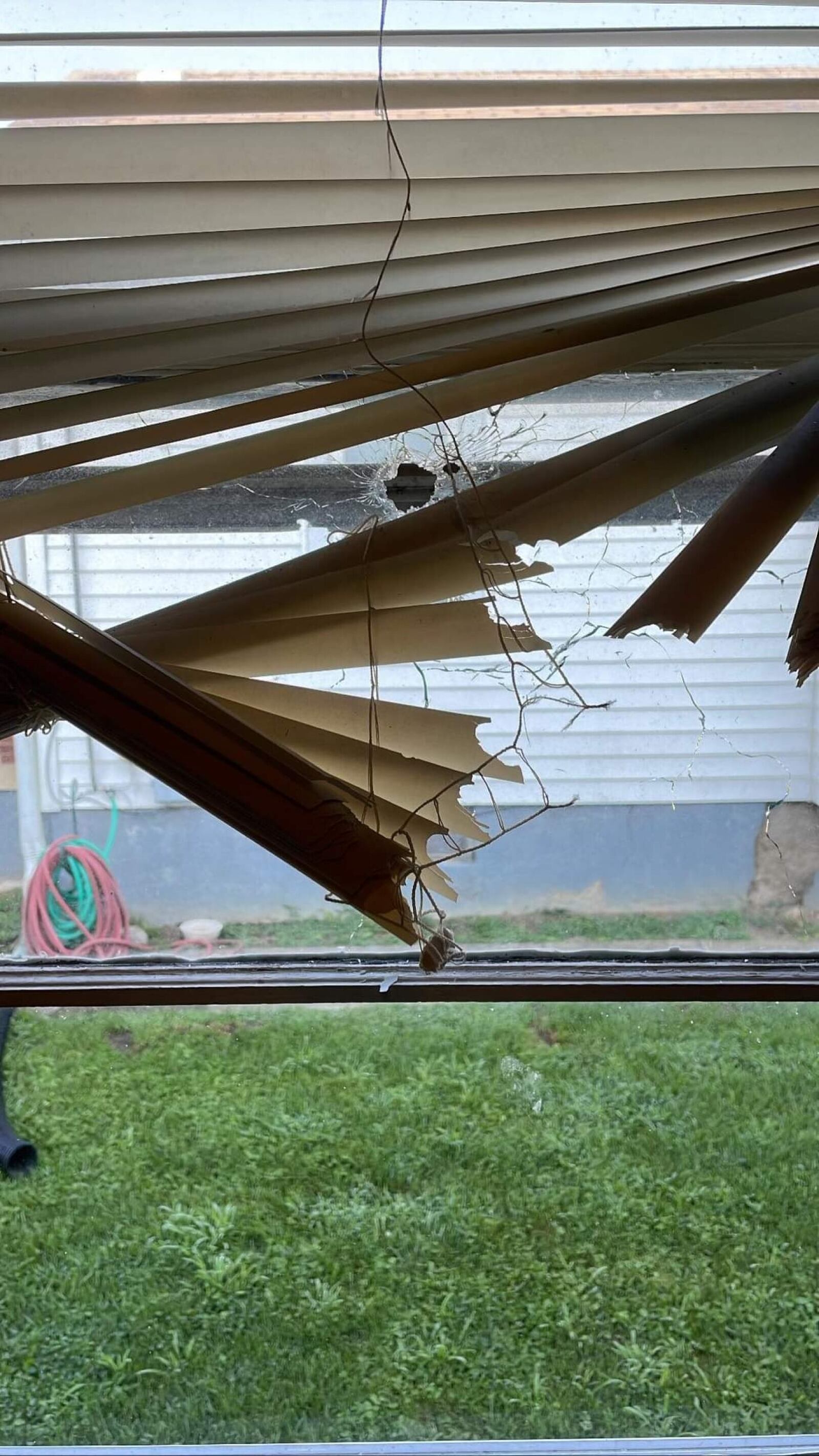 A window broken at a Hamilton home after a gunman opened fire on the house. CONTRIBUTED