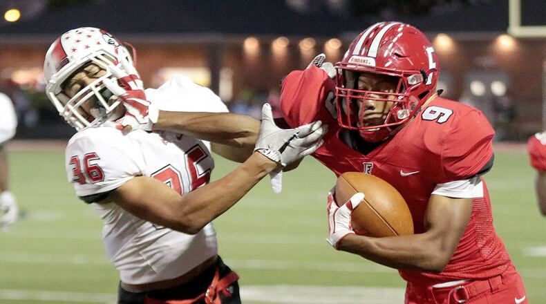 Fairfield’s JuTahn McClain (9) stiff-arms Colerain’s Deshawn Pace on a run during a game at Fairfield Stadium on Oct. 13, 2017. CONTRIBUTED PHOTO BY TONY TRIBBLE/WCPO.COM