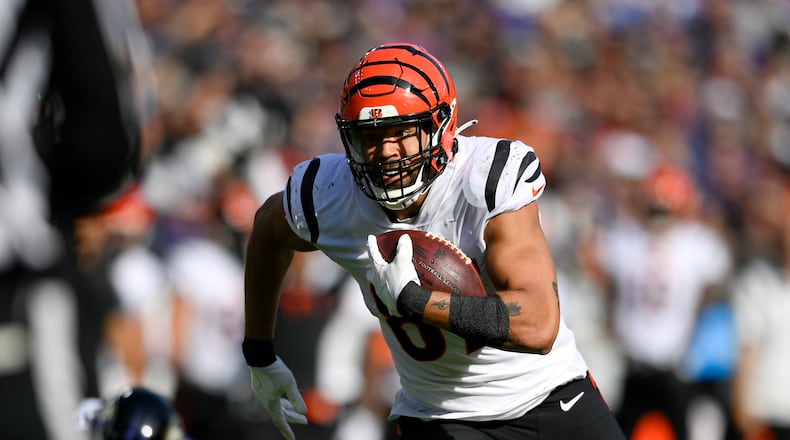 Cincinnati Bengals tight end C.J. Uzomah runs with the ball before scoring after catching a pass from quarterback Joe Burrow, not visible, during the second half of an NFL football game against the Baltimore Ravens, Sunday, Oct. 24, 2021, in Baltimore. (AP Photo/Nick Wass)