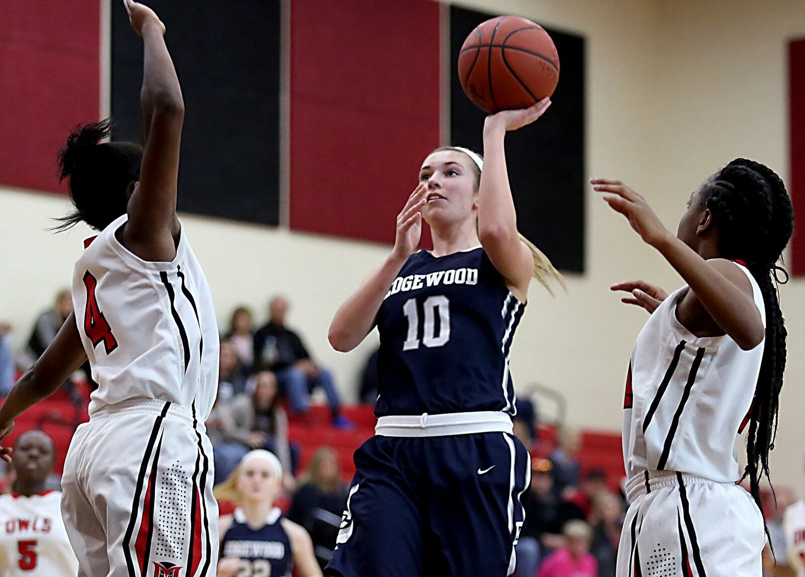 Edgewood guard Lauren Gerber gets off a shot between Mt. Healthy’s Taylor Dickerson (4) and Natya Kaiser (14) on Saturday afternoon at Mt. Healthy. CONTRIBUTED PHOTO BY E.L. HUBBARD