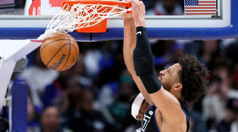 Detroit Pistons guard Cade Cunningham (2) dunks the ball against the Memphis Grizzlies during the first half of an NBA basketball game Friday, March 13, 2026, in Detroit. (AP Photo/Duane Burleson)