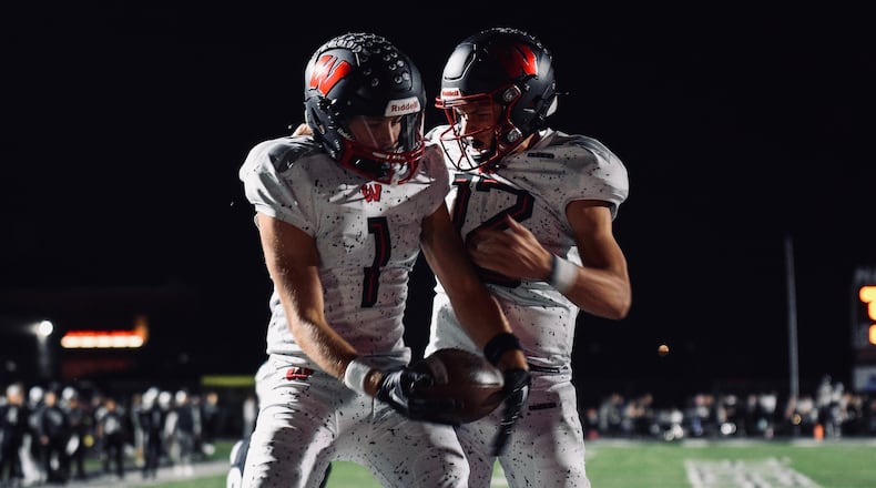 Lakota West's Brennan Remy (1) and Sam Wiles celebrate a touchdown vs. Lakota East on Friday night in Liberty Twp. West won the game 34-0. Jordan Phillips/CONTRIBUTED