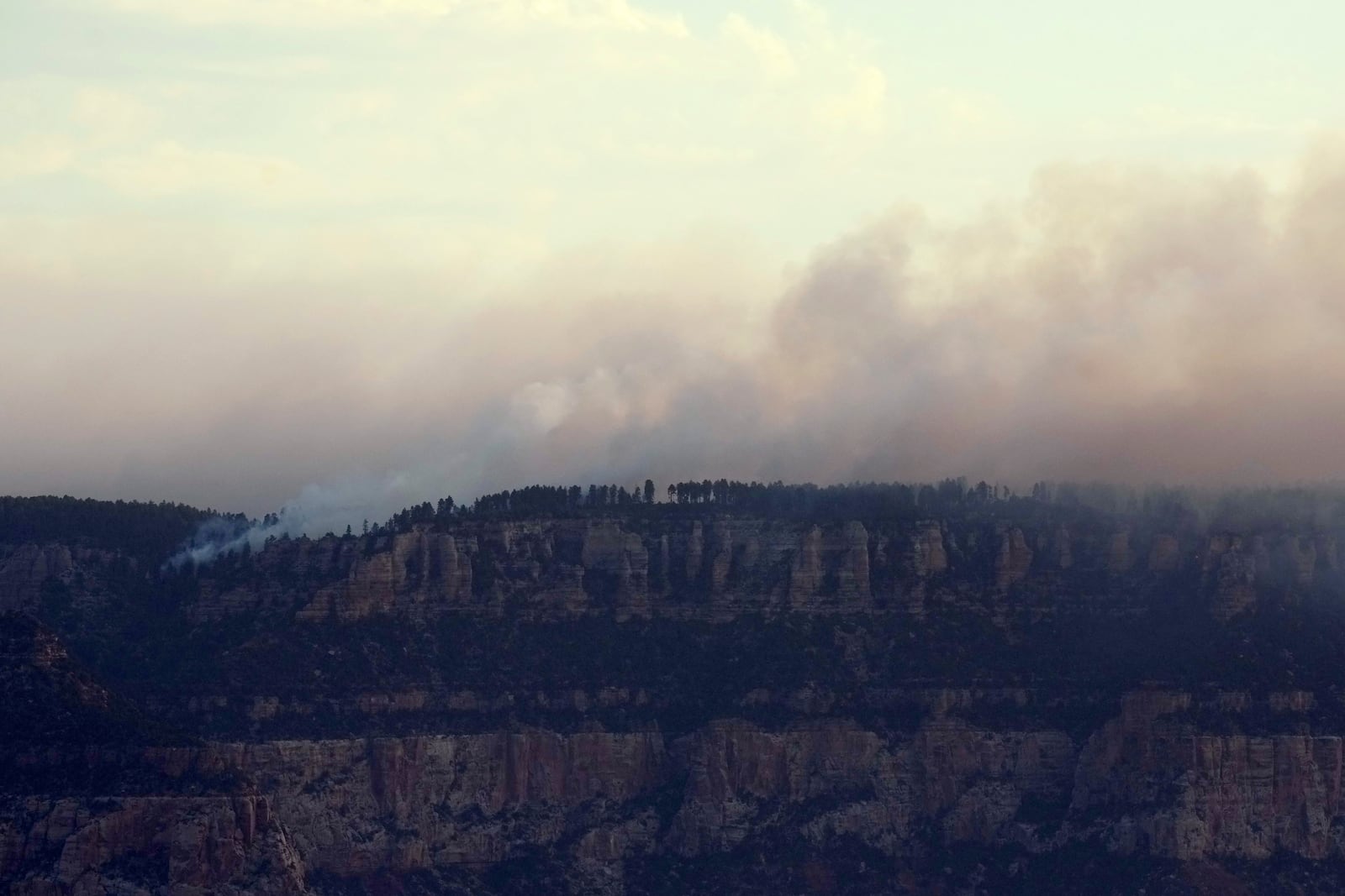 Smoke from the Dragon Bravo Fire moves across the Grand Canyon from the North Rim Tuesday, July 15, 2025, in Grand Canyon National Park, Ariz. (AP Photo/Ross D. Franklin)