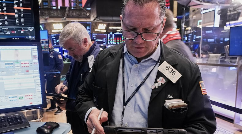 Traders Edward McCarthy, left, and Edward Curran work on the floor of the New York Stock Exchange, Thursday, Feb. 5, 2026. (AP Photo/Richard Drew)