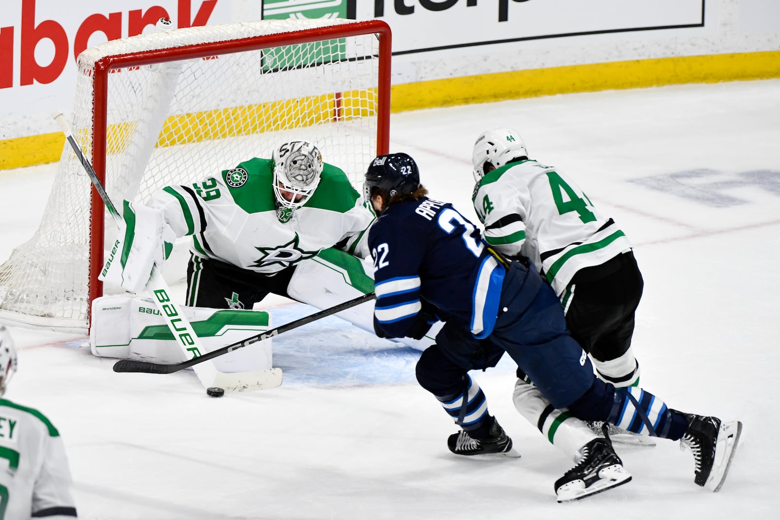 Dallas Stars goaltender Jake Oettinger (29) makes a save on Winnipeg Jets' Mason Appleton (22) during the third period of an NHL hockey playoff series in Winnipeg, Manitoba, Wednesday, May 7, 2025. (Fred Greenslade/The Canadian Press via AP)