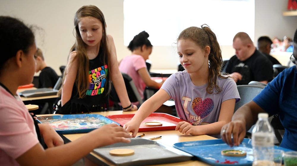 The artists at InsideOut Studio in Hamilton have worked with students at the Booker T. Washington Center for the past few summers thanks to funding from the Hamilton Community Foundation. Pictured are students working on mosaics at the BTW Center on Monday, July 7, 2025. Inspiration Studios and Booker T. Washington Center are examples of organizations involved in the 2025 Holiday Giving Hub. MICHAEL D. PITMAN/STAFF