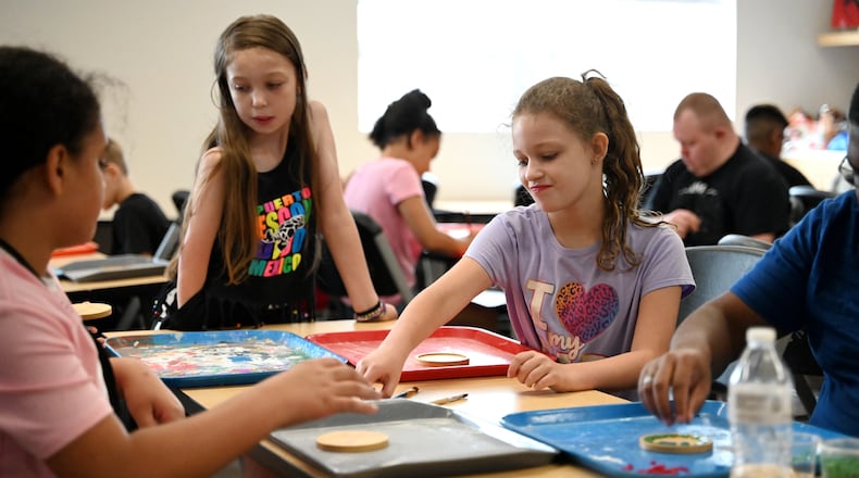 The artists at InsideOut Studio in Hamilton have worked with students at the Booker T. Washington Center for the past few summers thanks to funding from the Hamilton Community Foundation. Pictured are students working on mosaics at the BTW Center on Monday, July 7, 2025. Inspiration Studios and Booker T. Washington Center are examples of organizations involved in the 2025 Holiday Giving Hub. MICHAEL D. PITMAN/STAFF