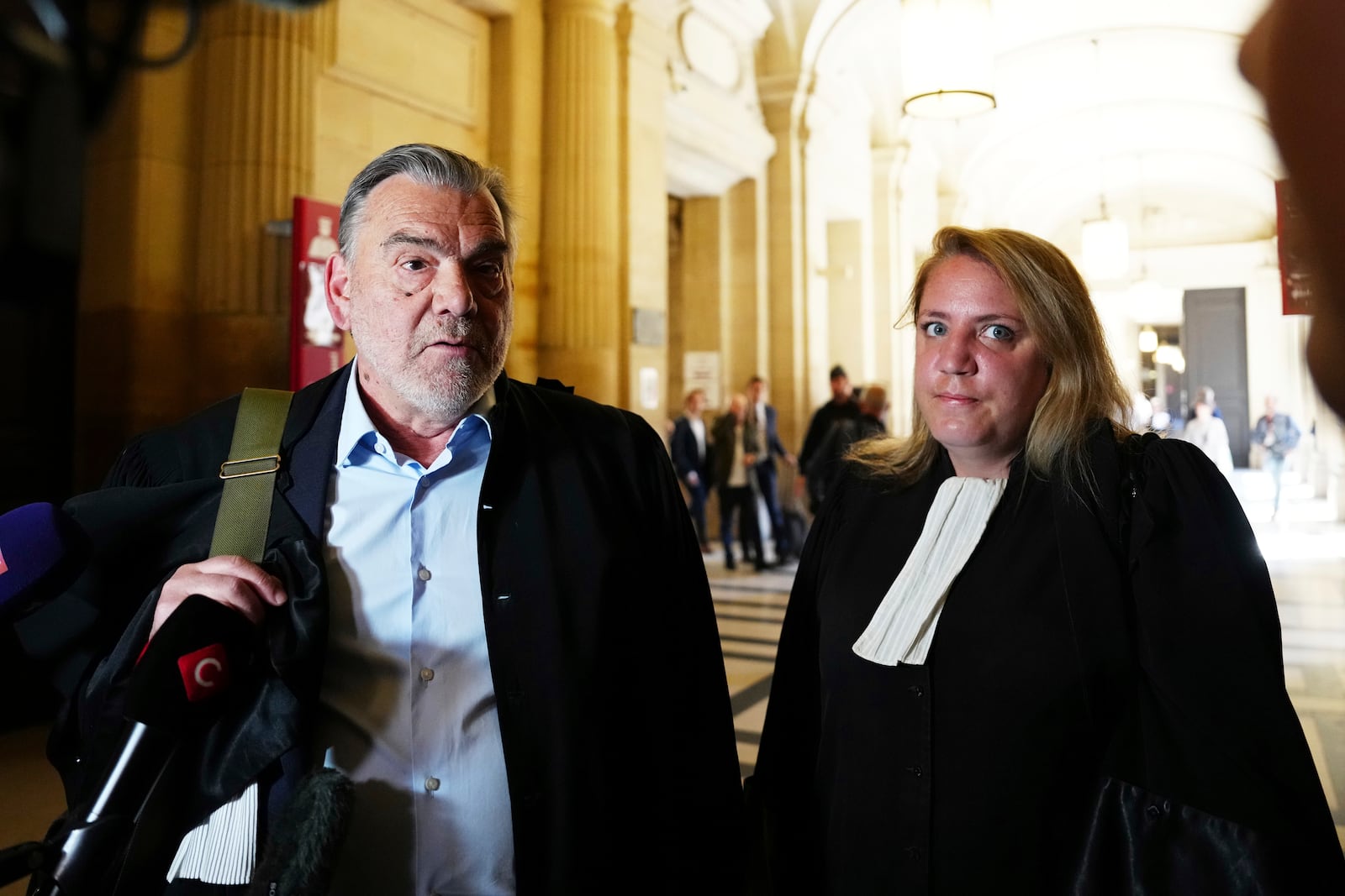 Franck Berton, left, and Chloe Arnaux, lawyers for Aomar Aït Khedache, one of the men accused in the 2016 armed robbery of Kim Kardashian, face reporters at the palace of justice Monday, April 28, 2025 in Paris. (AP Photo/Aurelien Morissard)