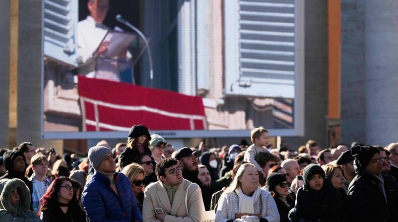 Faithful listen to Pope Leo XIV's Angelus noon prayer in St. Peter's Square at the Vatican, Sunday, Jan. 11, 2026. (AP Photo/Gregorio Borgia)