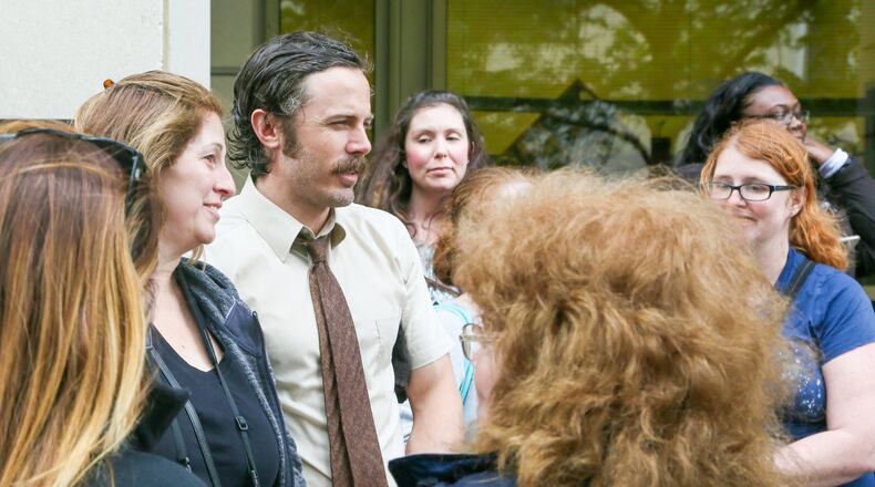 Casey Affleck poses for pictures with fans after finishing a scene for the Robert Redford movie The Old Man and the Gun, being filmed in Hamilton, Thursday, Apr. 27, 2017. GREG LYNCH / STAFF
