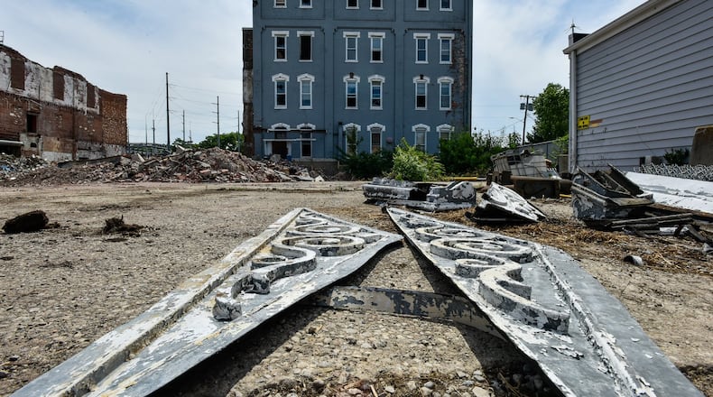TAMZ Construction is collecting decorative architectural pieces from the vacant office building of the former Beckett Mill / Mohawk Fine Papers on Dayton Street Wednesday, June 17 in Hamilton. Some of these items will find new life in buildings around Hamilton as ornamental decor. The building is slated to be demolished this week. NICK GRAHAM / STAFF