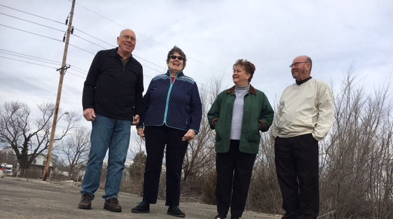 Dayton-area Delphi salaried retirees (from left), Tom Rose, Mary Miller, Marlane Bengry and Tom Green, standing on the foundation of the former Delphi Wisconsin Boulevard plant in Dayton. THOMAS GNAU/STAFF