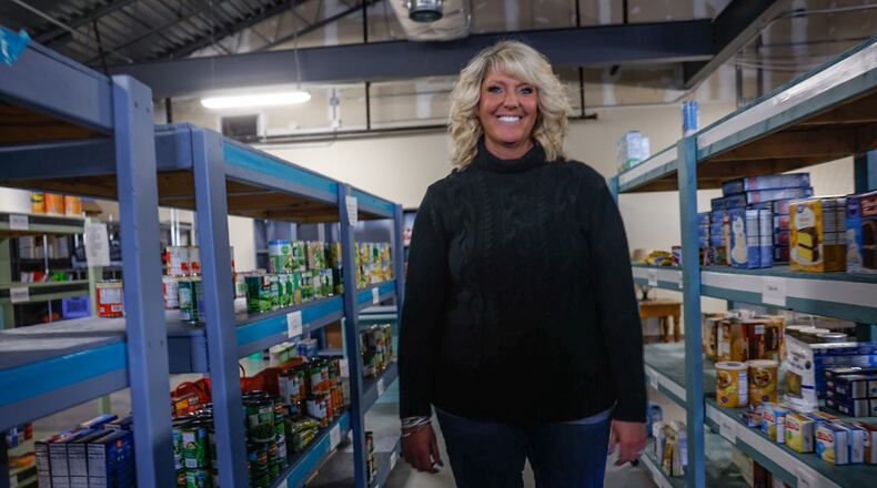 Springboro Community Assistance Center Director, Wendy Grothjan stands in the schools' large food pantry for students and families. FILE PHOTO