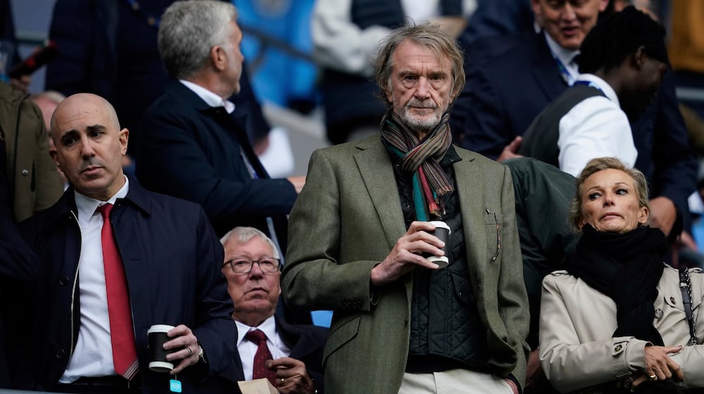 FILE - Manchster United co-owner Jim Ratcliffe stands in front of the former manager Alex Ferguson during the Premier League soccer match between Manchester City and Manchester United in Manchester, England, on Sept. 14, 2025. (AP Photo/Dave Thompson, File)