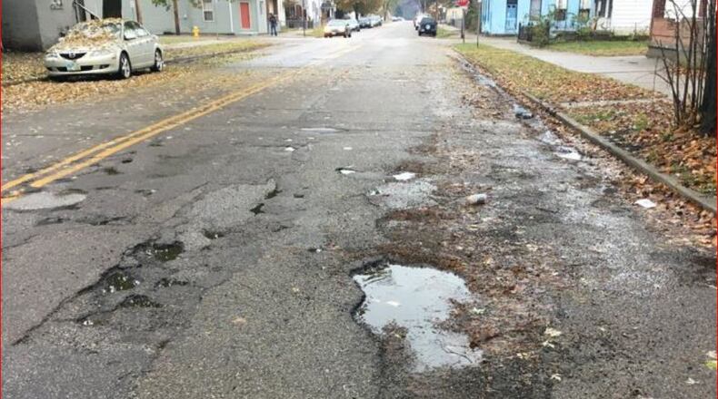 Many Hamilton streets have potholes, and many haven’t been repaved in 40 years. MIKE RUTLEDGE/STAFF