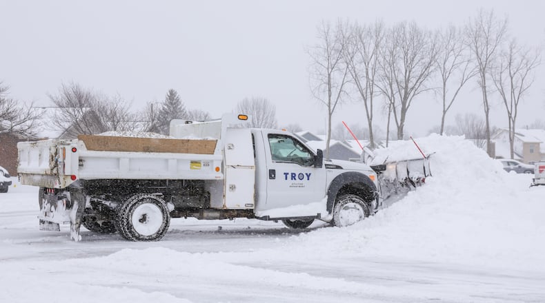 A City of Troy truck clears snow on Meadowpoint Drive on Sunday, Jan. 25. About eight inches had fallen in Troy as of 1 p.m. BRYANT BILLING/STAFF
