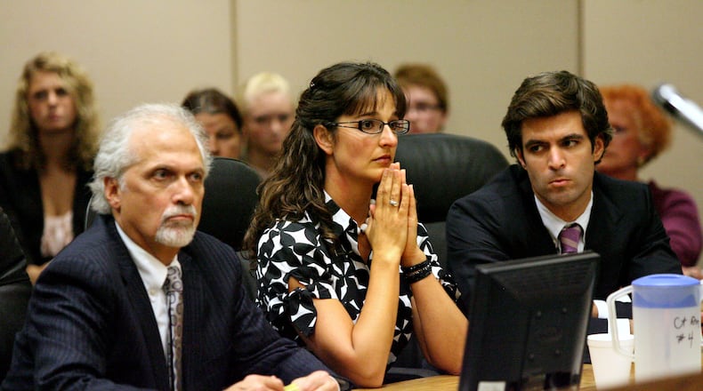 Stacy Schuler sits between her lawyers Charlie Rittgers (left) and Charlie M. Rittgers during her fourth day of trial in Warren County Common Pleas Court Thursday, Oct. 27, 2011. Schuler, 33, was sentenced to four years in prison after being found guilty on all 16 felony counts of sexual battery and three misdemeanor counts of providing alcohol to minors.