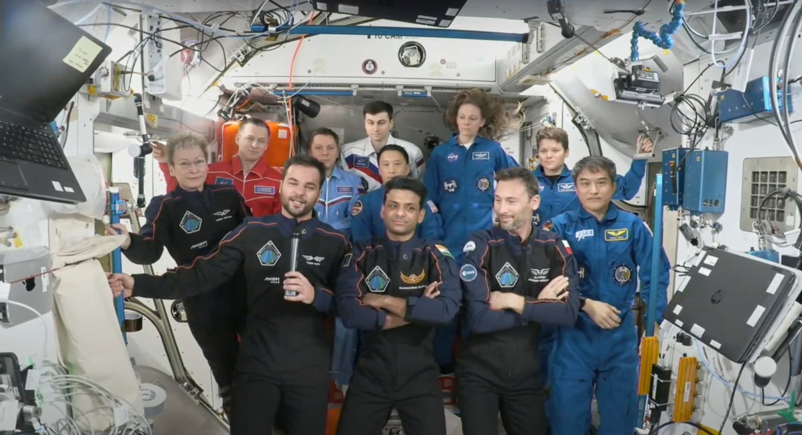 This photo provided by Axiom Space shows the private crew of four, in dark suits, from left, Axiom mission commander Peggy Whitson, Hungary's Tibor Kapu, India's Shubhanshu Shukla and Poland's Slawosz Uznanski-Wisniewski, during a farewell ceremony aboard the International Space Station on Sunday, July 13, 2025. (Axiom Space via AP)