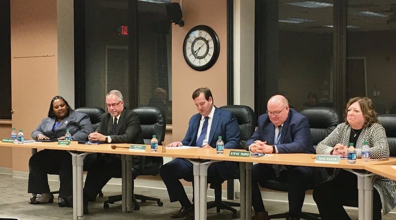 For the first time in 13 years two females will be a part of the governing board that oversees the 10,000-student Hamilton Schools. The Rev. Shaquila Mathews, far left, and Margaret Baker, far right, were sworn on to the Hamilton Board Education at Thursday evening’s meeting. (Photo By Michael D. Clark/Journal-News)