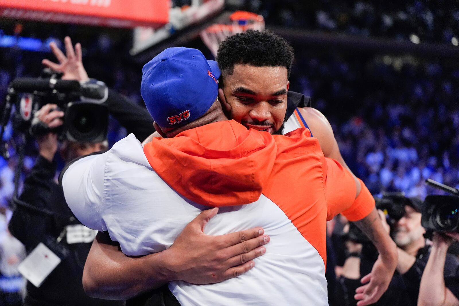 New York Knicks center Karl-Anthony Towns hugs his dad, Karl Towns, Sr., following Game 1 in an NBA basketball first-round playoff series against the Detroit Pistons, Saturday, April 19, 2025, in New York. (AP Photo/Julia Demaree Nikhinson)