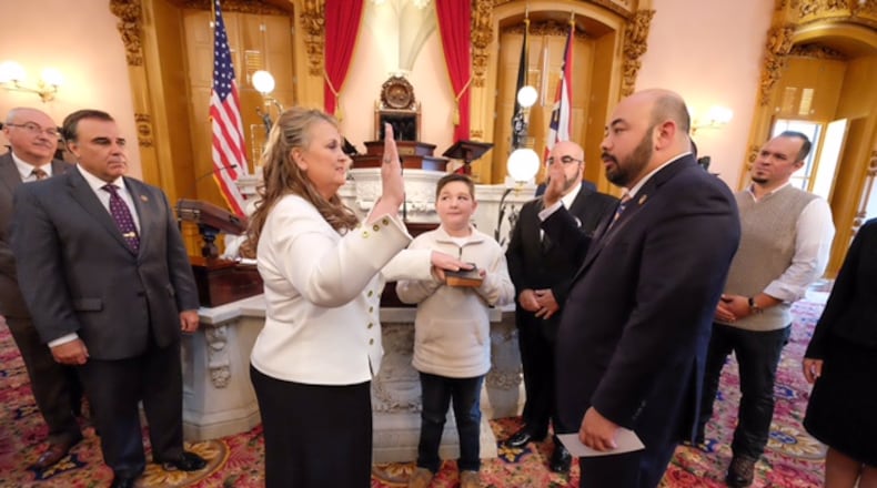 Speaker of the Ohio House Cliff Rosenberger, right, swears in newly elected Ohio Rep. Candice Keller on Wednesday afternoon on the floor of the Ohio House. She fills the unexpired term vacated by former Ohio Rep. Tim Derickson. She begins her full two-year term in January. CONTRIBUTED