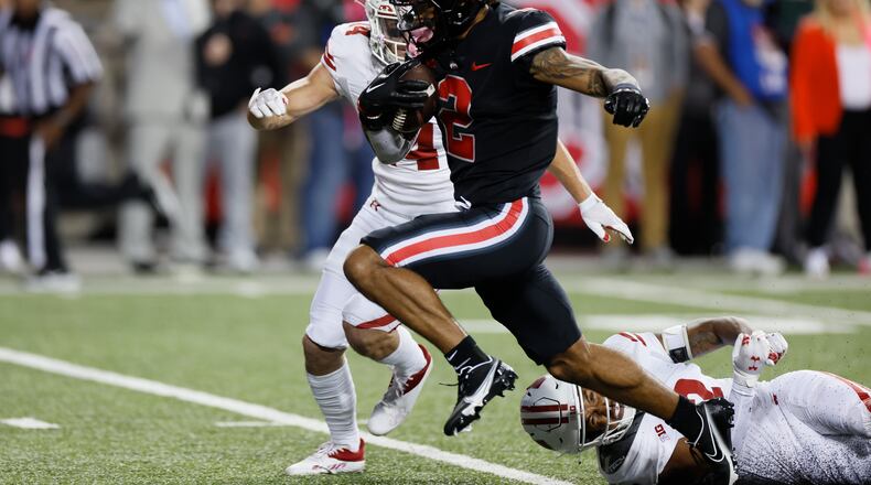 Ohio State receiver Emeka Egbuka, center, scores a touchdown past Wisconsin defensive backs Preston Zachman, left, and Max Lofy during the second half of an NCAA college football game Saturday, Sept. 24, 2022, in Columbus, Ohio. (AP Photo/Jay LaPrete)