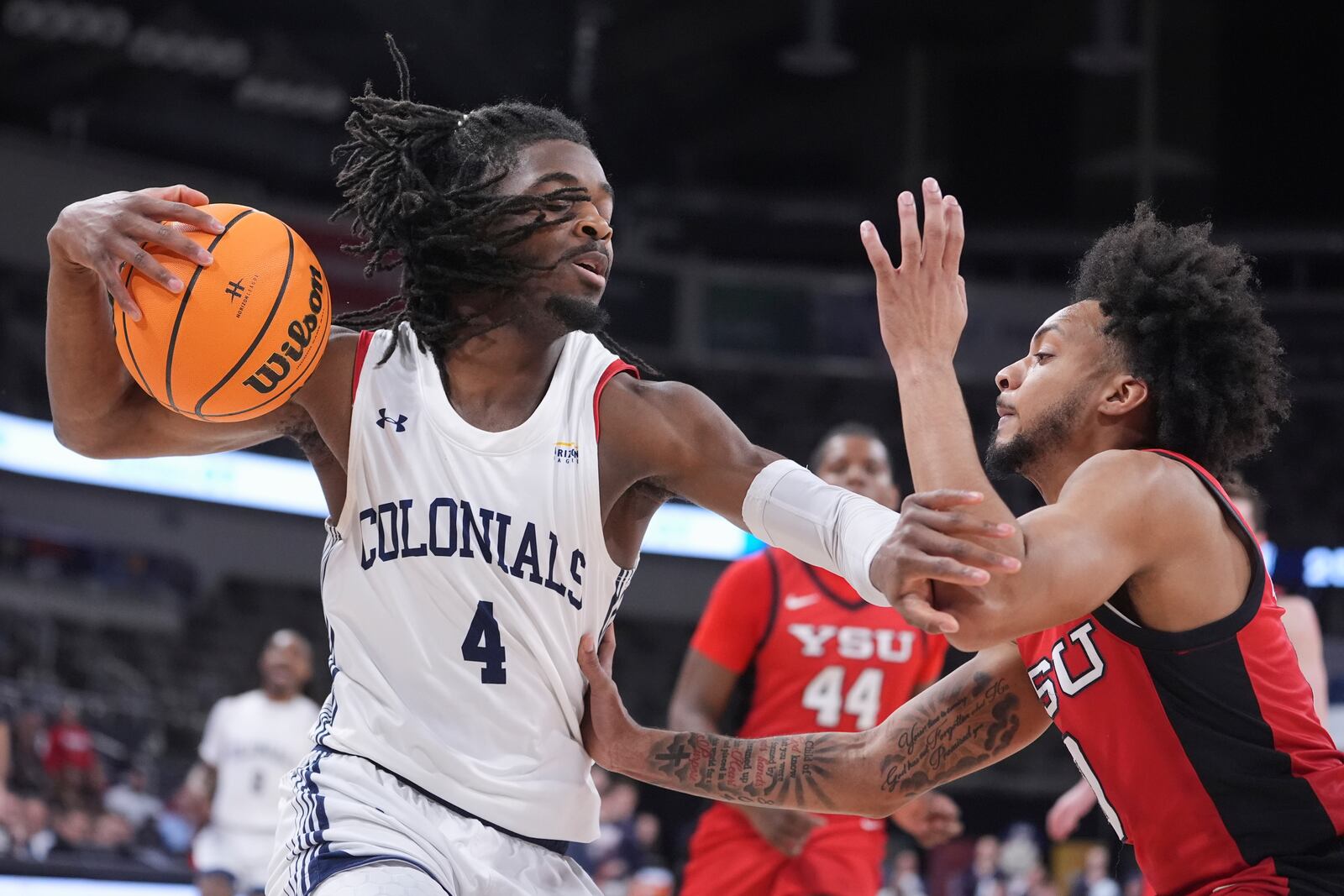Robert Morris guard Josh Omojafo (4) holds off Youngstown State guard Jason Nelson (0) in the first half of an NCAA college basketball game in the championship of the Horizon League tournament in Indianapolis, Tuesday, March 11, 2025. (AP Photo/Michael Conroy)