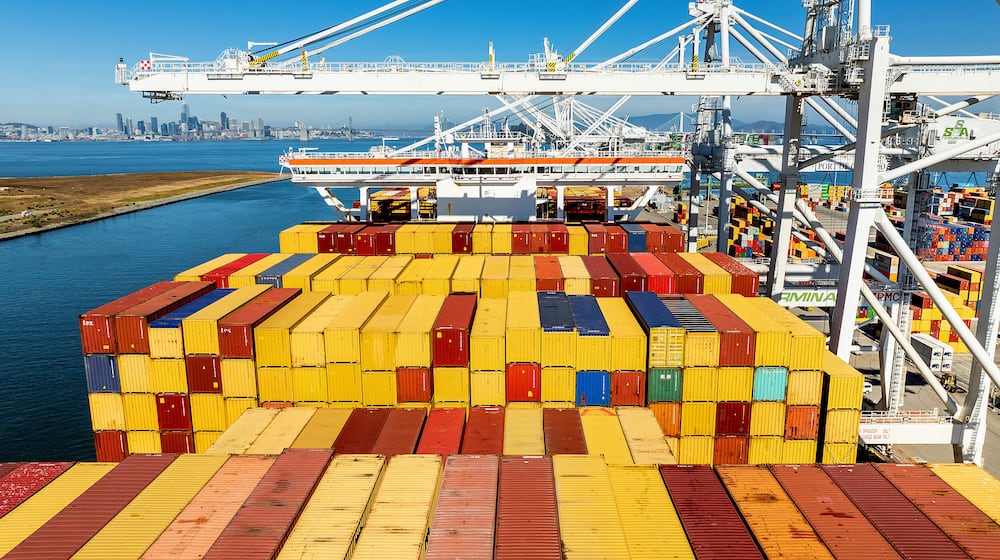 FILE - Cargo containers line a ship at the Port of Oakland on Wednesday, Aug. 6, 2025, in Oakland, Calif. (AP Photo/Noah Berger, File)