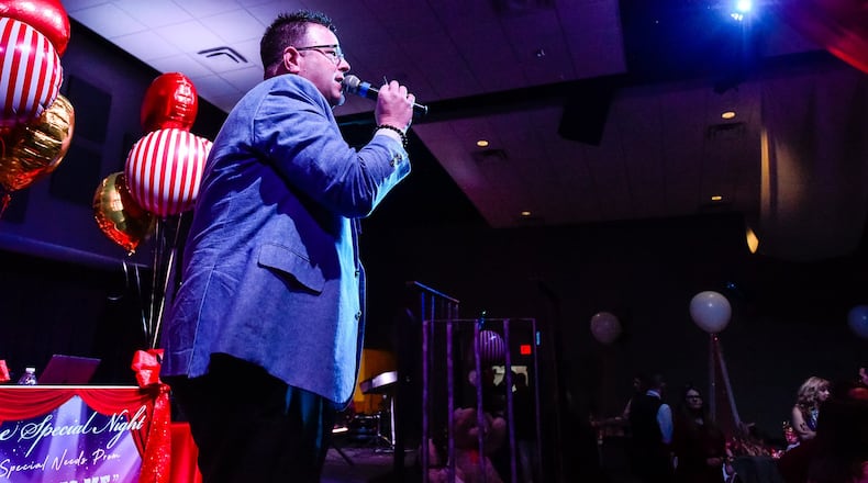 Pastor Lamar Ferrell served as master of ceremonies as special needs students from local schools were treated like royalty during “One Special Night” this year at Berachah Church in Middletown. NICK GRAHAM/STAFF