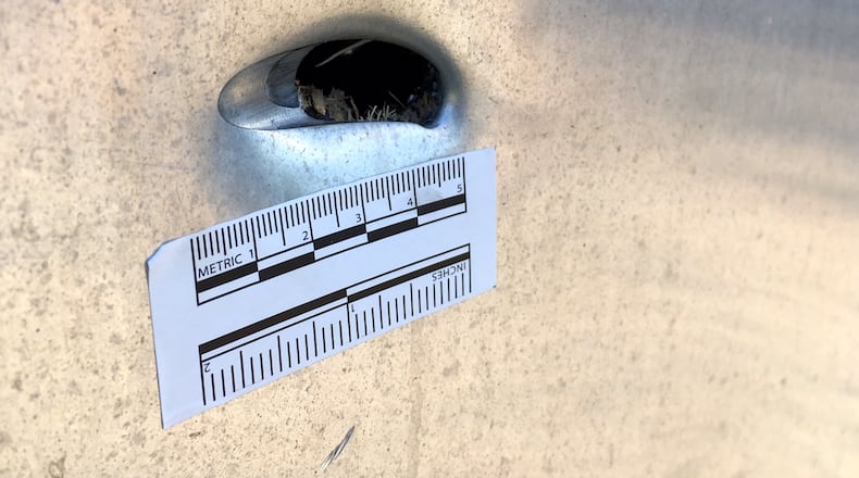 Bullet holes are seen on a box by railroad tracks on Jackson Road. NICK GRAHAM/STAFF