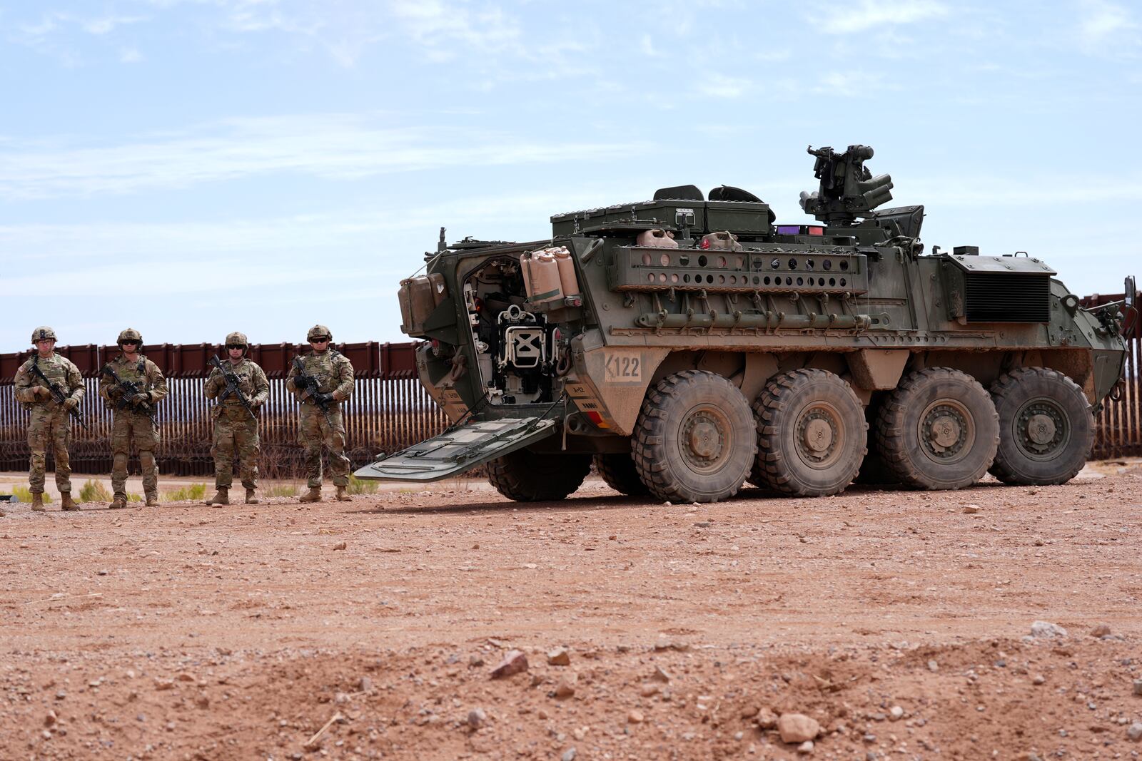 Members of the U.S. Army 212 Infantry 2nd Brigade stand next to an M1126 Stryker vehicle parked at the US-Mexico border, as part of Joint Task Force Southern Border, Thursday, April 3, 2025, in Douglas, Ariz. (AP Photo/Ross D. Franklin)