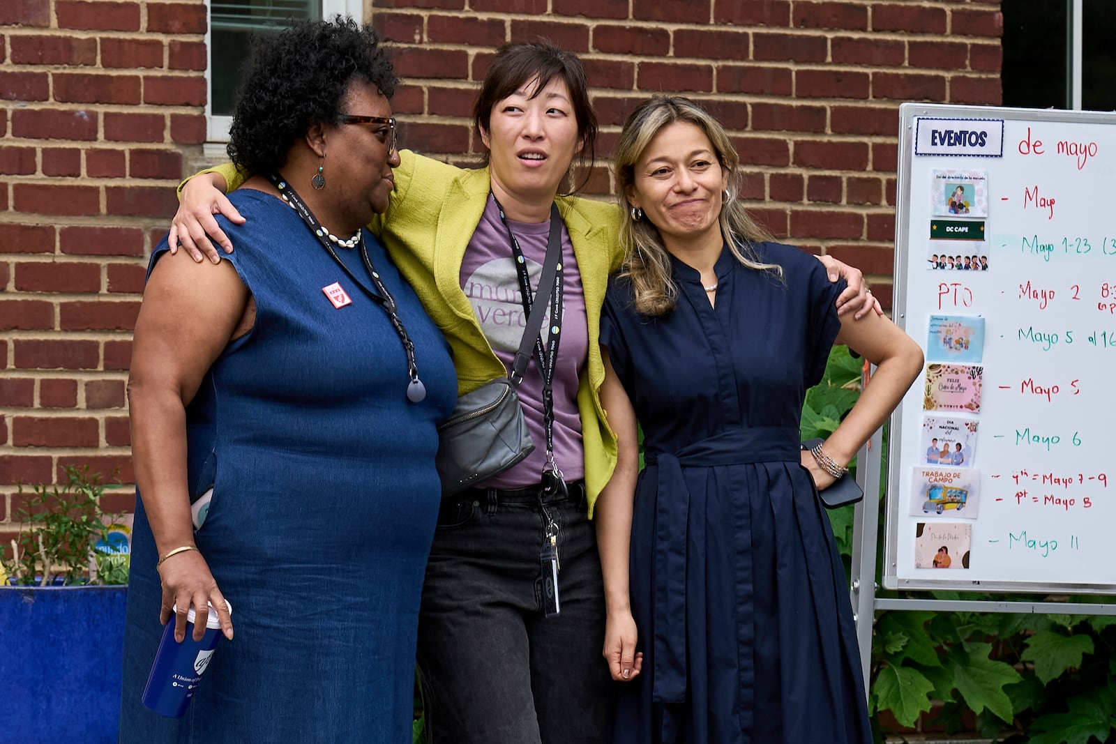 Staff at Mundo Verde Public Charter School hug as staff and parents keep watch for Immigration and Customs Enforcement (ICE) agents amid fears of impending arrests at schools, Tuesday, May 6, 2025. (AP Photo/Jacquelyn Martin)