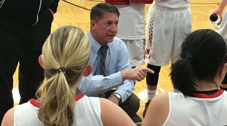 Madison coach Brian McGuire talks to his team during a timeout in Saturday’s Division II sectional game against Dunbar at Lebanon. RICK CASSANO/STAFF