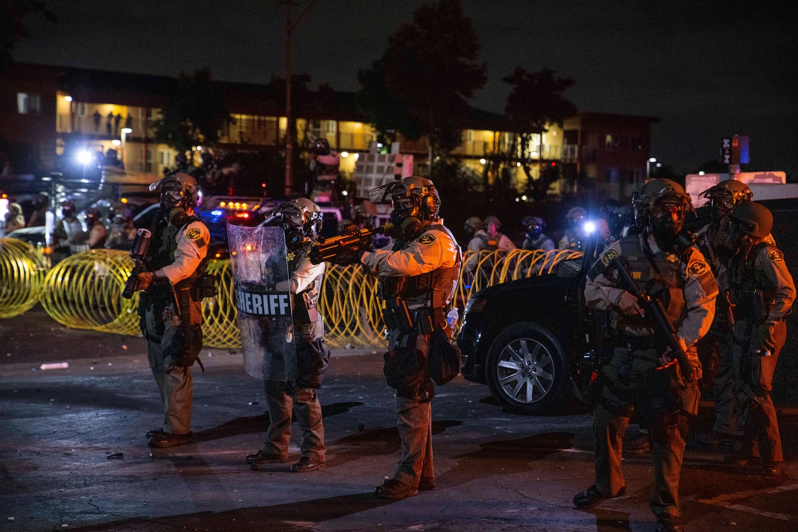 Los Angeles County Sheriffs stand during a protest in Compton, Calif., Saturday, June 7, 2025, after federal immigration authorities conducted operations. (AP Photo/Ethan Swope)