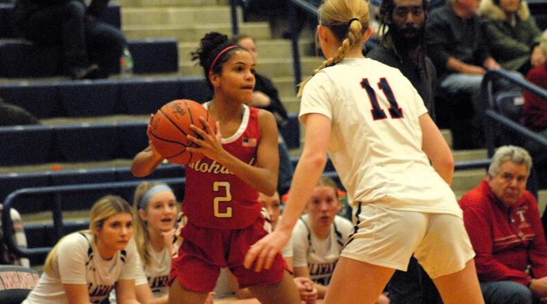 Madison's Ally Crim (2) looks for a passing lane while being guarded by Talawanda's Megan Watt (11) on Monday night in Oxford. Chris Vogt/CONTRIBUTED