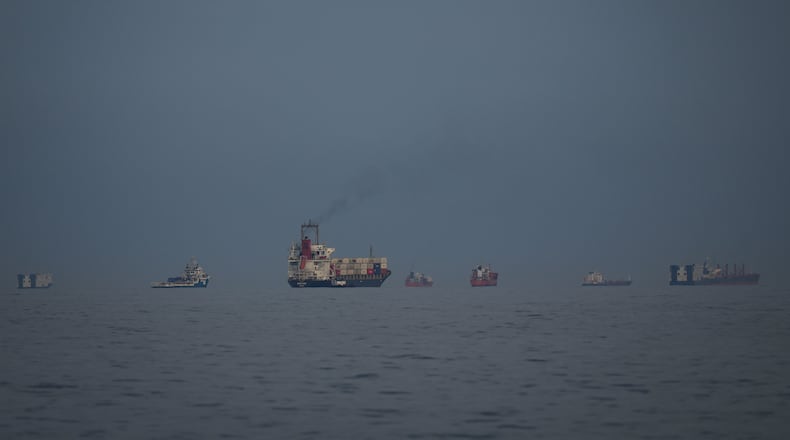 Oil tankers and cargo ships line up in the Strait of Hormuz as seen from Khor Fakkan, United Arab Emirates, Wednesday, March 11, 2026. (AP Photo/Altaf Qadri)