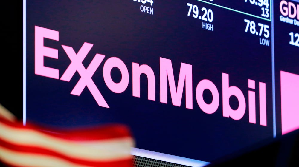 FILE - The logo for ExxonMobil appears above a trading post on the floor of the New York Stock Exchange, April 23, 2018. (AP Photo/Richard Drew, File)