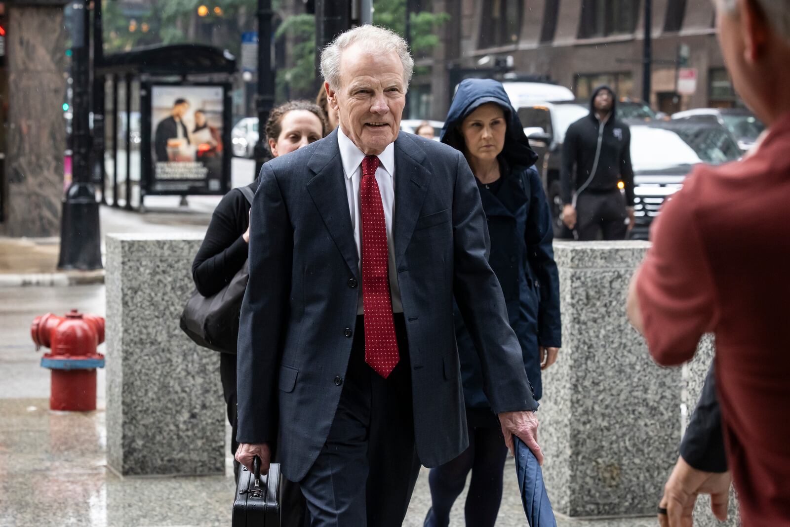 Flanked by attorneys and supporters, Illinois' former House Speaker Michael Madigan walks into the Dirksen Federal Courthouse for his sentencing hearing, Friday, June 13, 2025, in Chicago. (Ashlee Rezin/Chicago Sun-Times via AP)