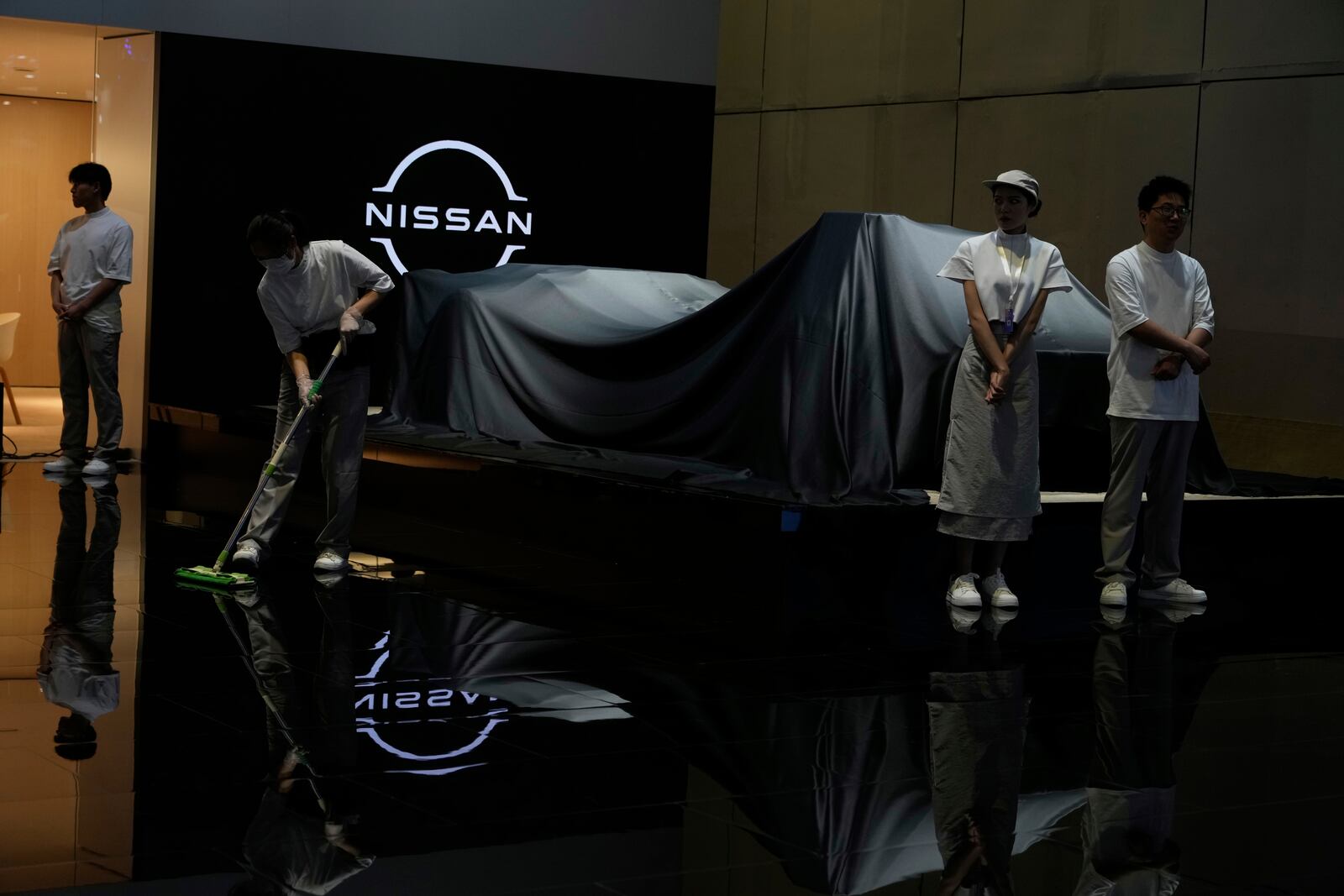 Exhibitors prepare for an unveiling at the Auto Show in Shanghai, Wednesday, April 23, 2025. (AP Photo/Ng Han Guan)