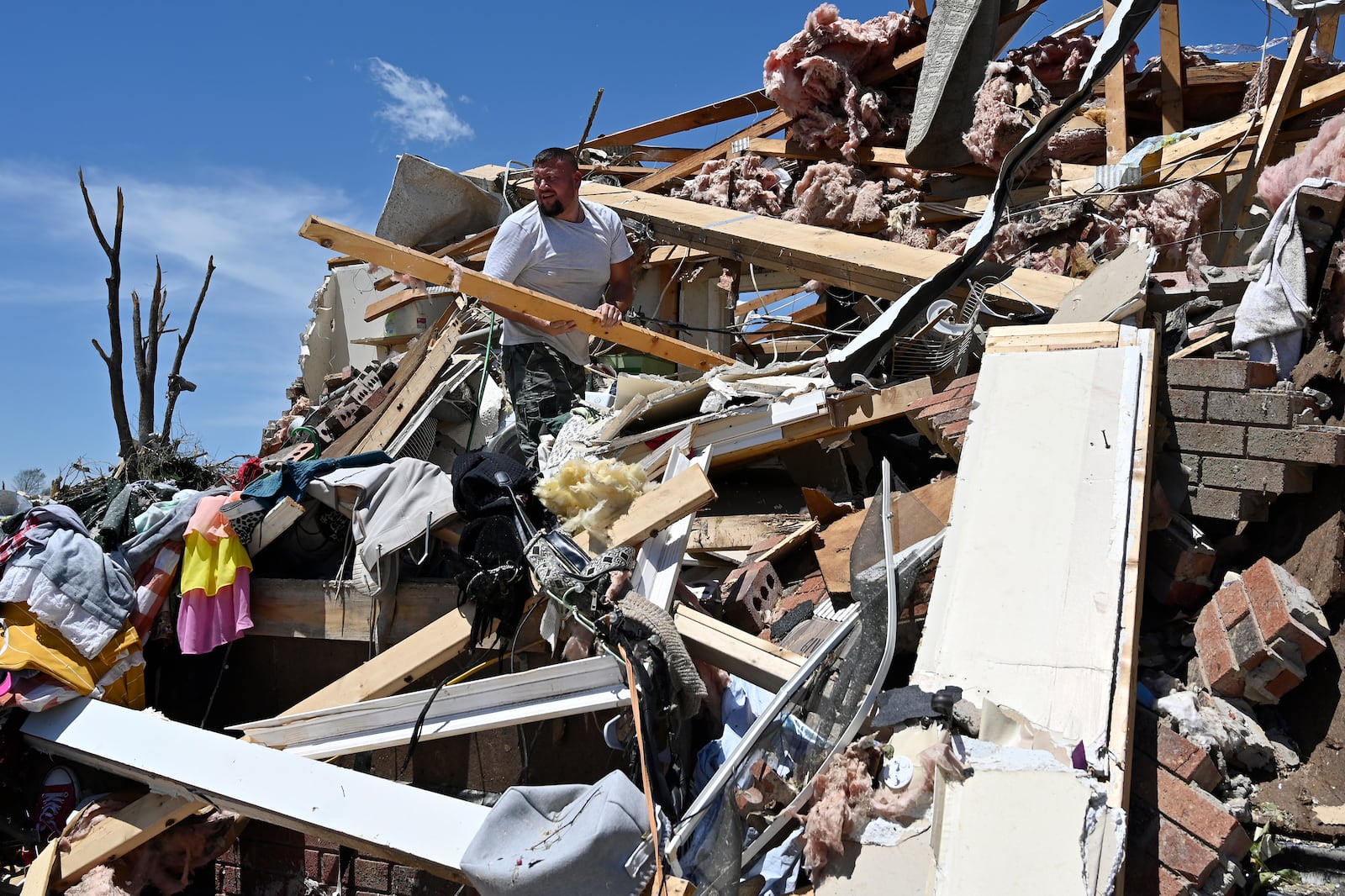 Anthony Broughton stands amid his destroyed home following severe weather in the Sunshine Hill neighborhood of London, Ky., Saturday, May 17, 2025. (AP Photo/Timothy D. Easley)
