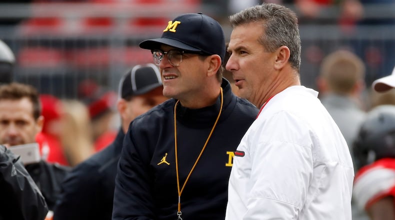 COLUMBUS, OH - NOVEMBER 26: (R-L) Head coach Urban Meyer of the Ohio State Buckeyes and Head coach Jim Harbaugh of the Michigan Wolverines talk on the field prior to their game at Ohio Stadium on November 26, 2016 in Columbus, Ohio. (Photo by Gregory Shamus/Getty Images)