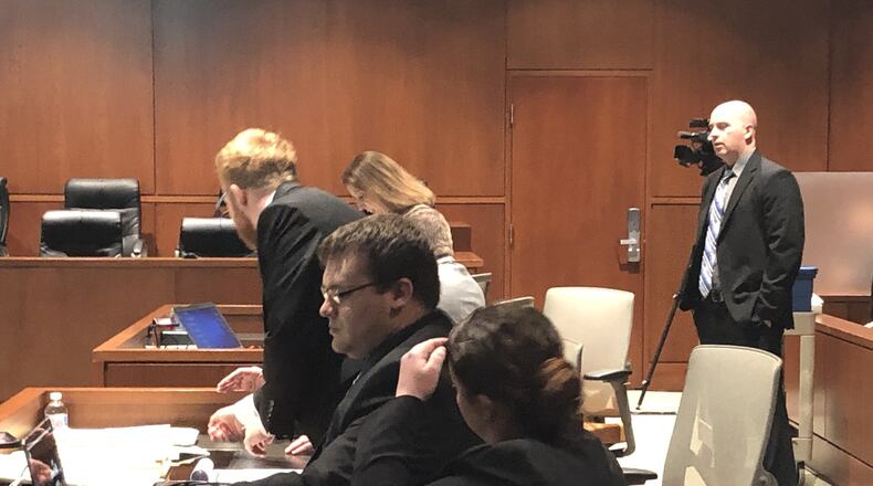 John Austin Hopkins and his lawyers prepare for trial Tuesday afternoon in Warren County Common Pleas Court. STAFF/LAWRENCE BUDD