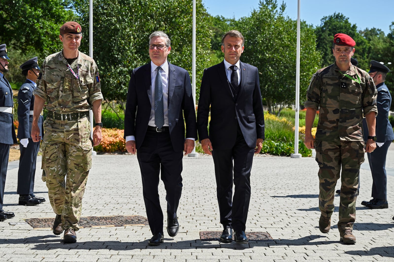 British Prime Minister Keir Starmer, centre left, and French President Emmanuel Macron, centre right, arrive for a joint military visit to the MARCOM centre, maritime command centre in Northwood, London, Thursday July 10, 2025. (Leon Neal/Pool Photo via AP)
