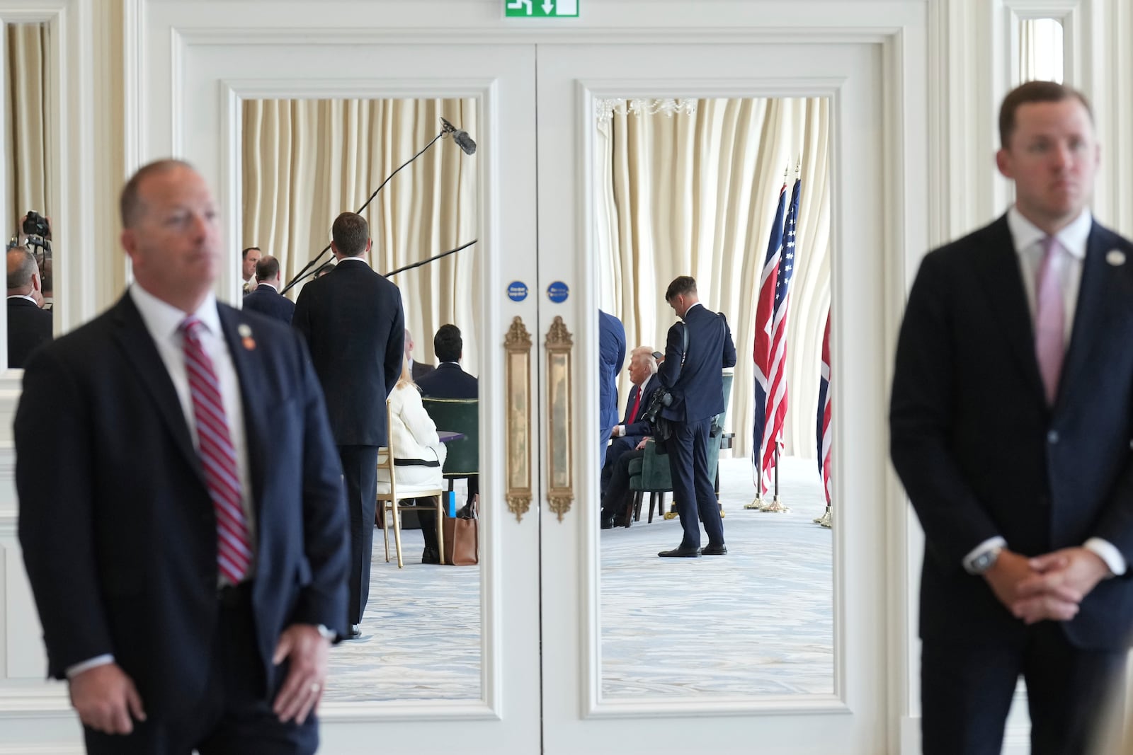 President Donald Trump, background, speaks with the media during a meeting with Britain's Prime Minister Keir Starmer at the Trump Turnberry golf course in Turnberry, Scotland Monday, July 28, 2025. (AP Photo/Jacquelyn Martin)