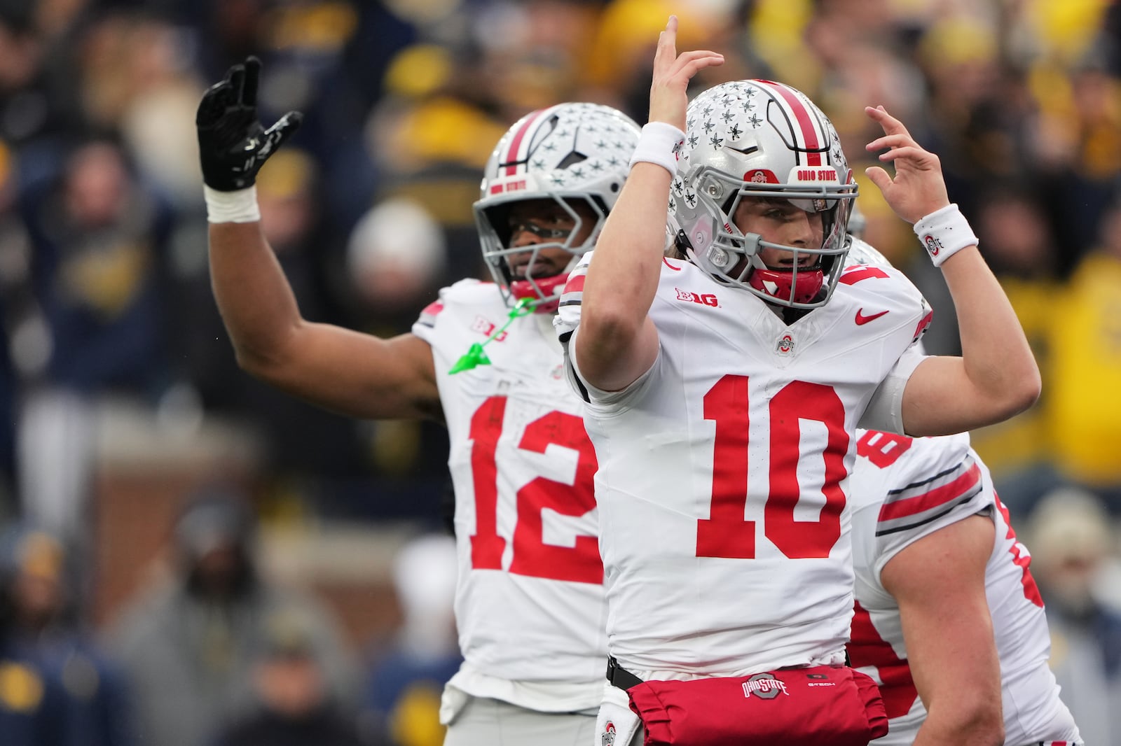 Ohio State quarterback Julian Sayin, right, celebrates near running back CJ Donaldson Jr. after scoring a touchdown during the first half of an NCAA college football game against Michigan, Saturday, Nov. 29, 2025, in Ann Arbor, Mich. (AP Photo/Ryan Sun)