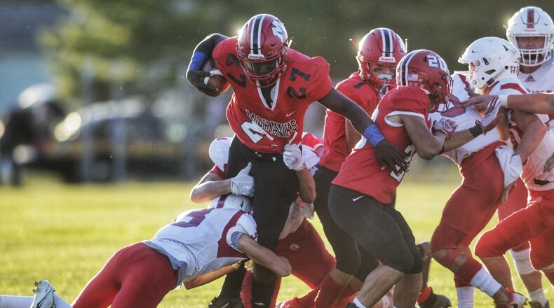 Madison's Dontai Pendleton fights for extra yardage against Carlisle at Brandenburg Field on Friday, Sept. 18, 2020. Nick Graham/STAFF